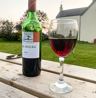 A bottle of wine on a picnic table