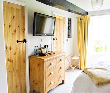 The TV and a chest of drawers in room two