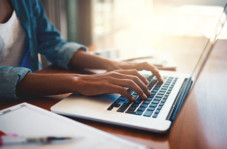 A person typing on a laptop